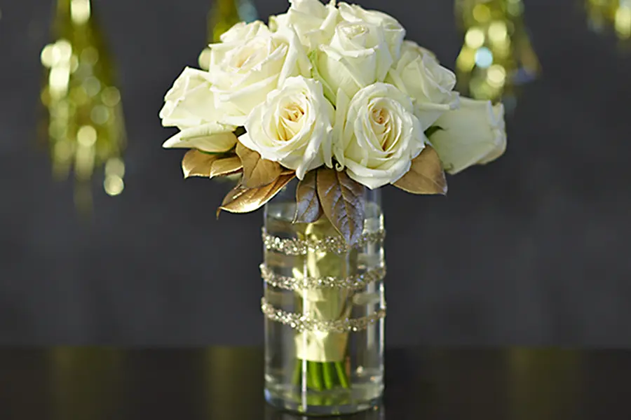 white roses in glitter vase