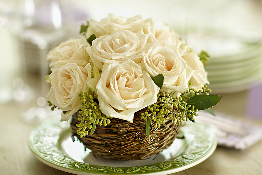 Small centerpiece with white roses and seeded eucalyptus