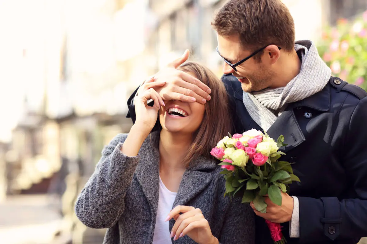 Boyfriend surprising girl with flowers