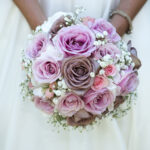 Close-up photo from a bride holding her pink wedding bouquet