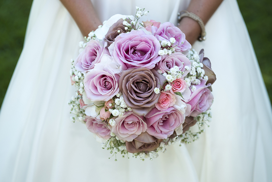 Close-up photo from a bride holding her pink wedding bouquet