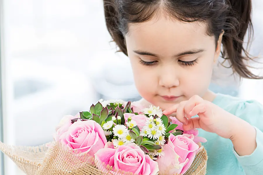 DIY Mother's Day Flower Gift with girl holding flower arrangement