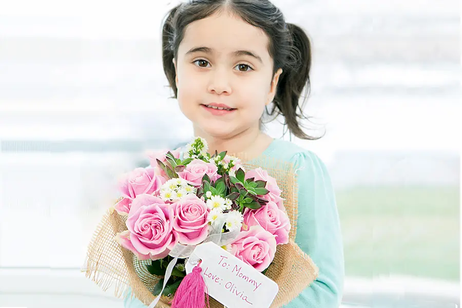 DIY Mother's Day Flower Gift with girl holding rose bouquet