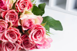 a photo of rose month with a bouquet of pink roses