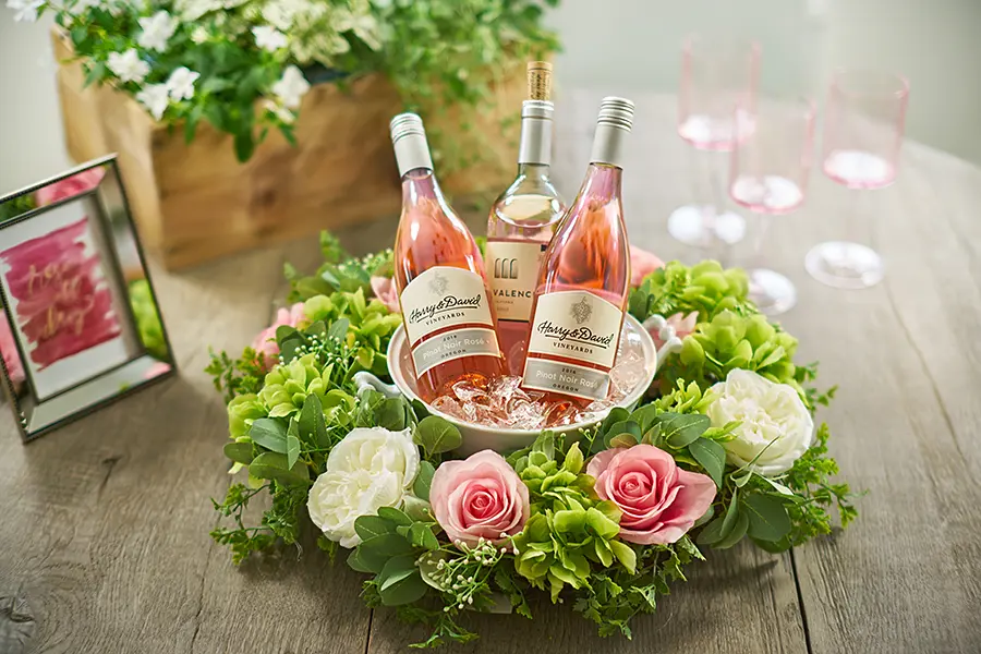 a photo of a roses and rosé wreath with a faux rose wreath