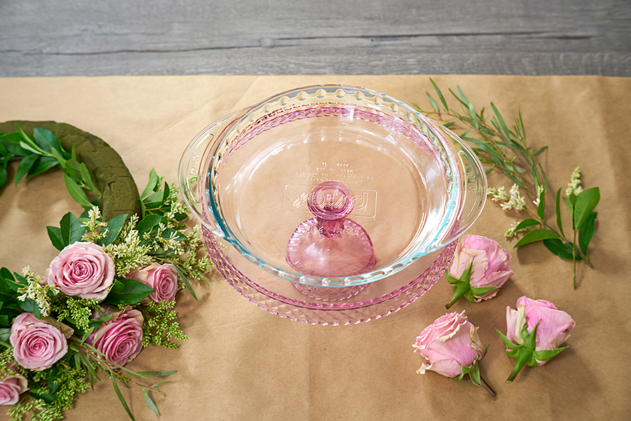a photo of a roses and rosé wreath with  a shallow dish for the base
