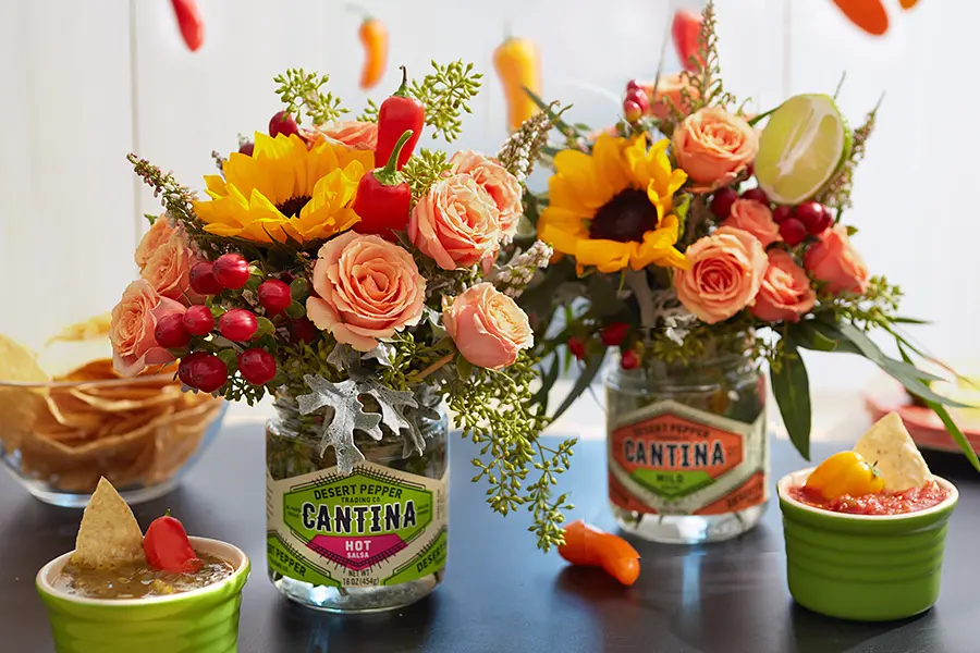 taco decor with salsa jars filled with flowers