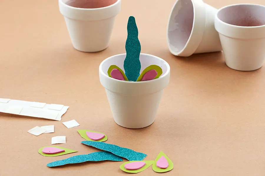 unicorn decorations with gluing horn and ears in pot