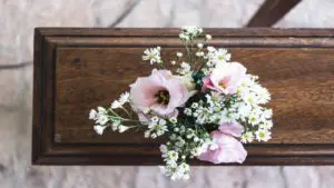 sympathy flowers with funeral flowers on a casket