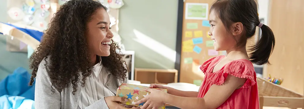 gifts for teachers with Girl giving teacher a gift