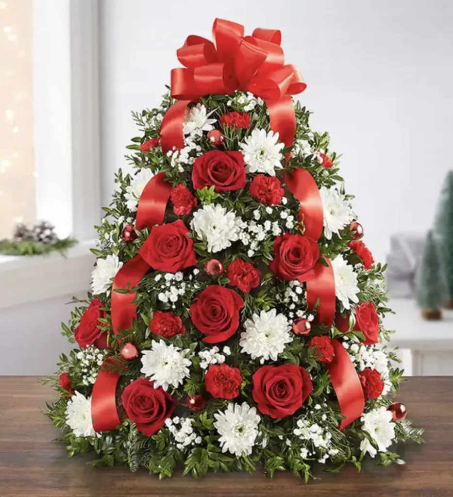 A photo of a Christmas tree made out of flowers.