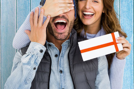 Woman giving gift to man