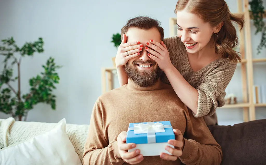 gift giving with woman and man with gift