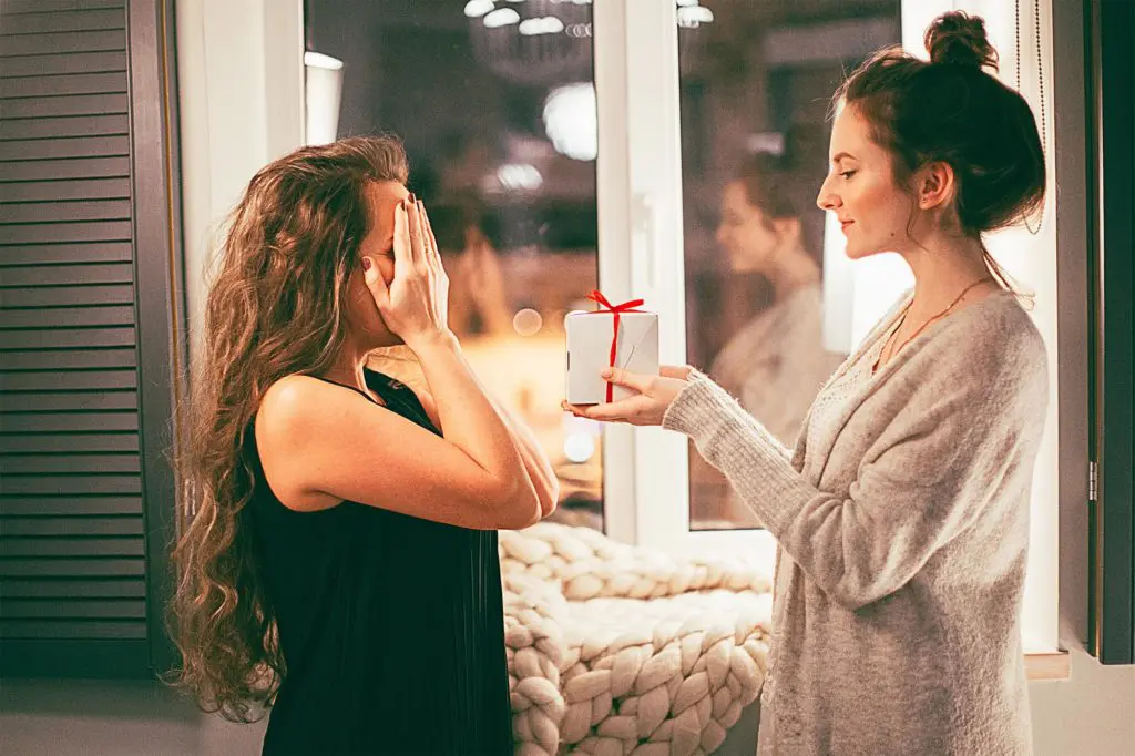 gift giving with woman giving woman gift