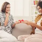 Excited woman getting gift from her friend