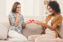Excited woman getting gift from her friend