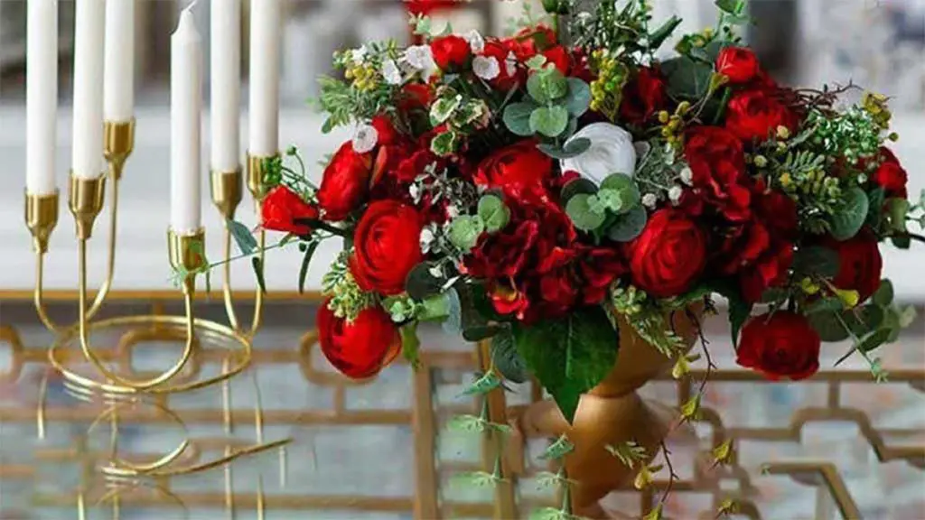 Red flowers in gold vase