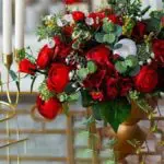 Red flowers in gold vase