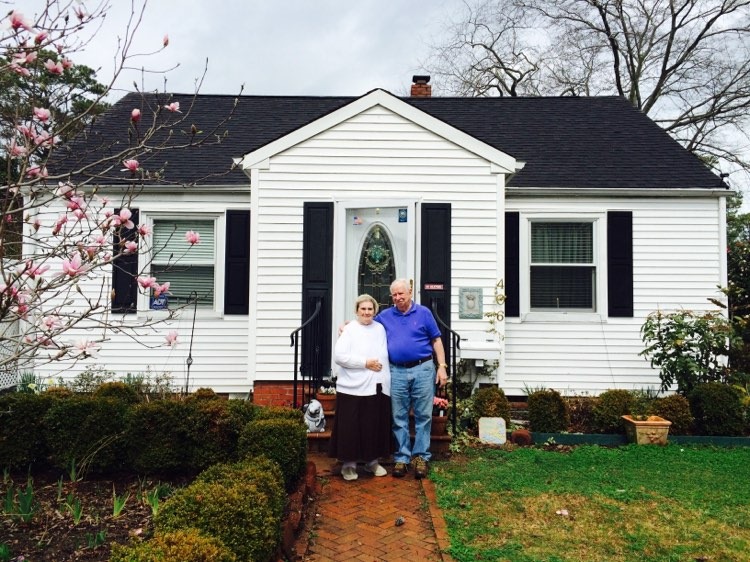 Daniel and Kathleen Reed stand outside their home.