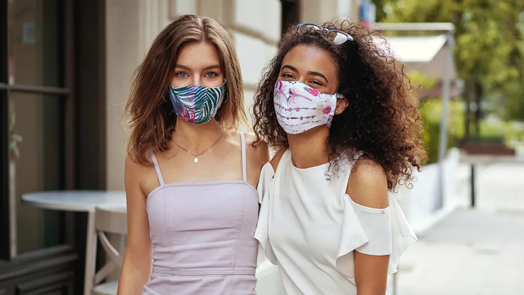 Two women wearing masks