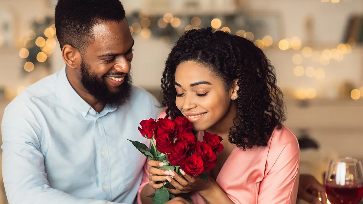 a photo of rose care with woman receiving roses