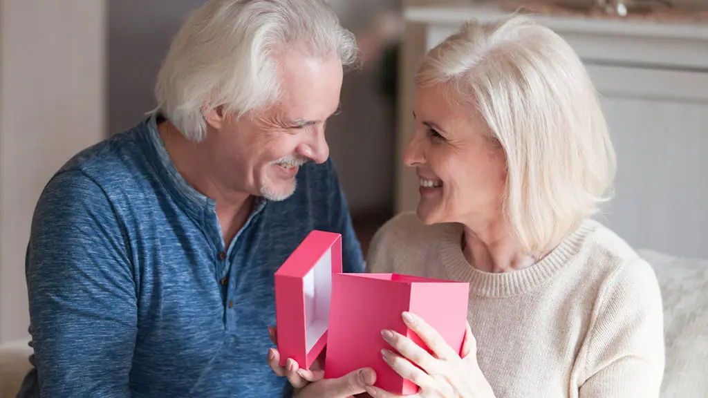 Valentine’s Day Gift Guide with Senior couple with gift in pink box