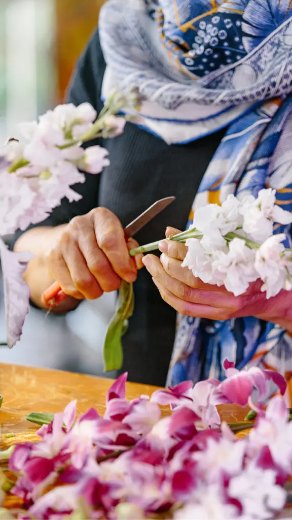 A close-up shot of local florist Vivian Chang arranging flowers at her Los Angeles-area shop