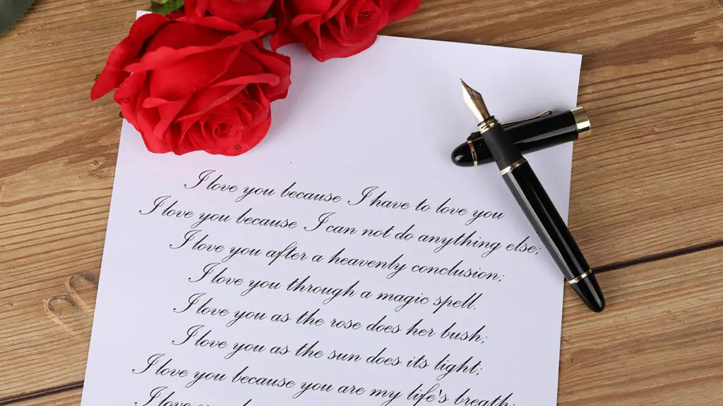 A photo showing a love poem with a fountain pen and roses