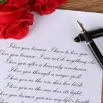 A photo showing a love poem with a fountain pen and roses