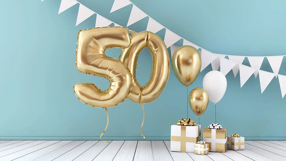 photo of birthday milestones with two balloons marking the 50th milestone