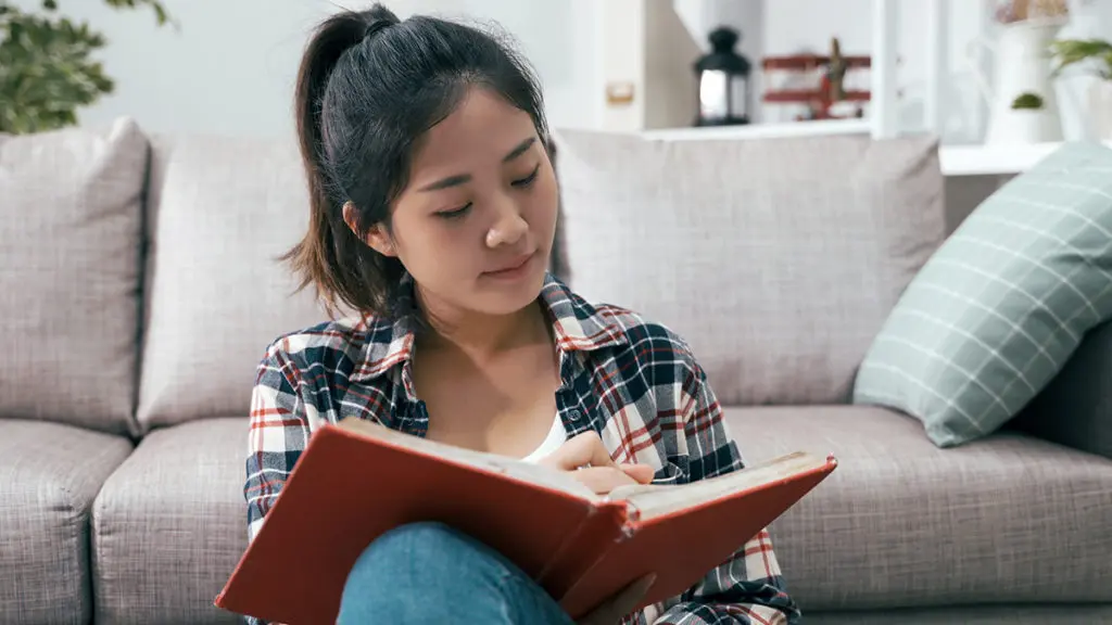 Woman writes her thoughts in a journal.