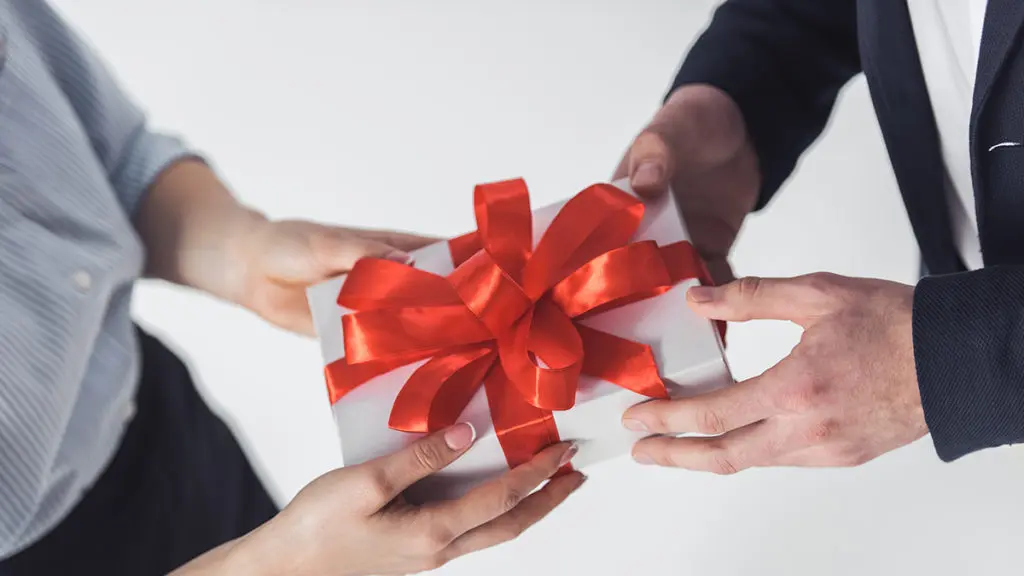 Man and woman holding gift box