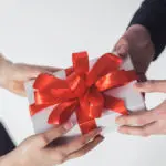 Man and woman holding gift box