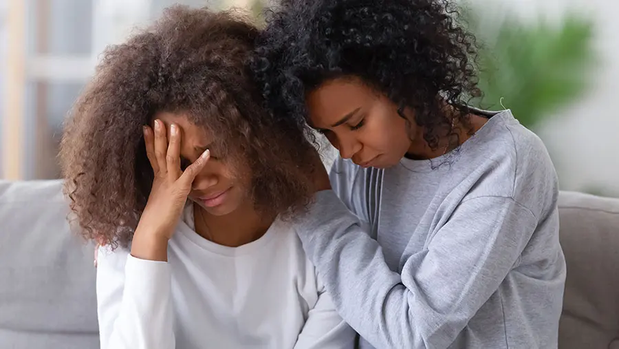 Two women  grieving