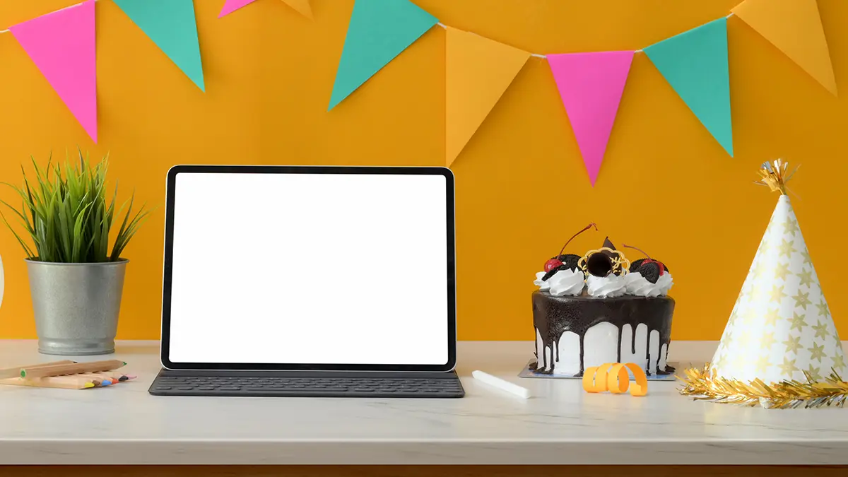 Laptop surrounded by birthday decor