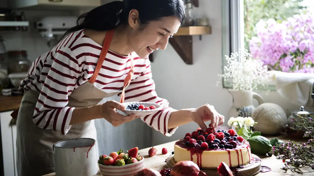 Woman making berry cheesecake