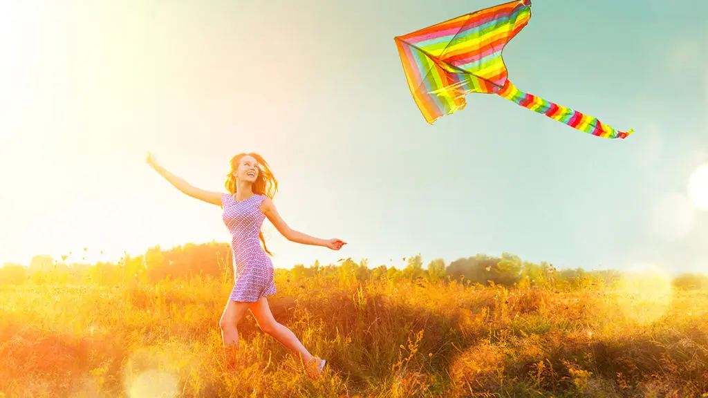 Woman running with a kite