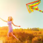 Woman running with a kite