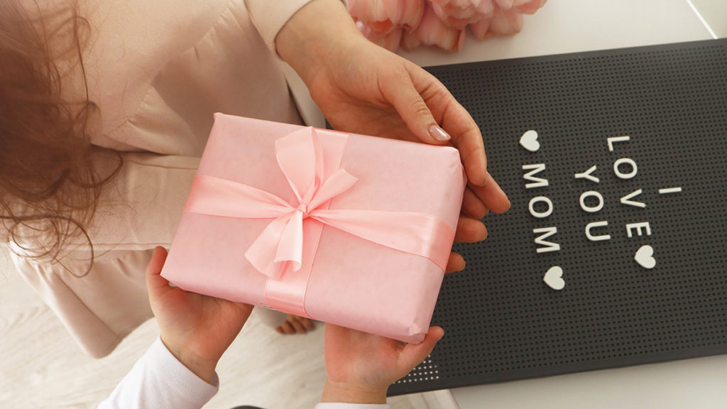 Child holding pink gift box