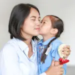 Girl kissing mother