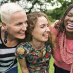 Five women laughing together