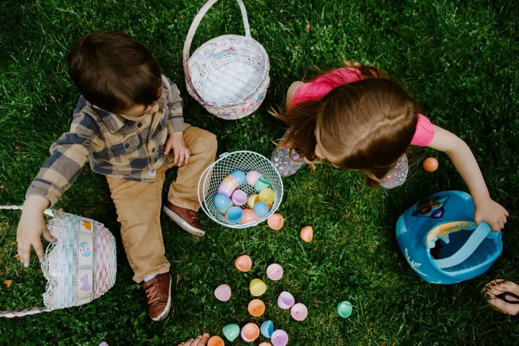 Boy and girl collecting Easter eggs