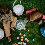 Boy and girl collecting Easter eggs