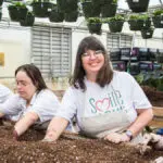 Smile Farms Famers work on a planting bed