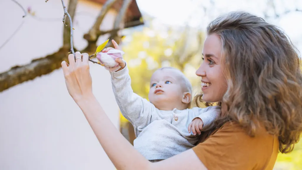Mommy brain isn't bad -- it's one of the benefits of motherhood and another reason to celebrate moms. In this photo, a mom shows her baby a tree branch.