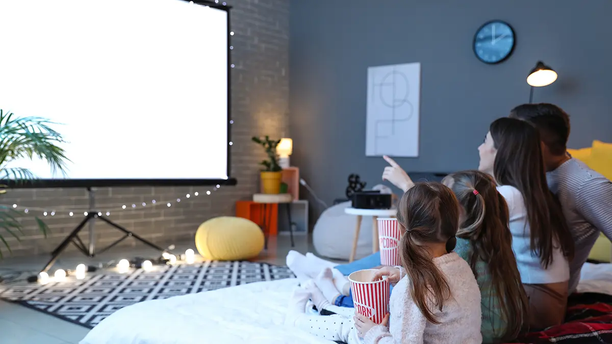 Young family watching movie at home