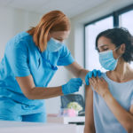 Nurse giving patient a shot