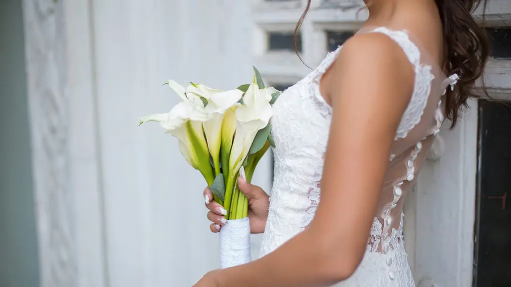 Wedding flower symbolism with Bride holding calla lily bouquet