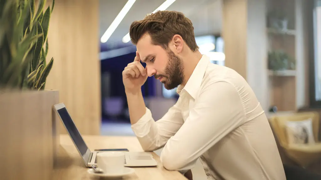 Photo of man looking at laptop