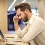 Photo of man looking at laptop